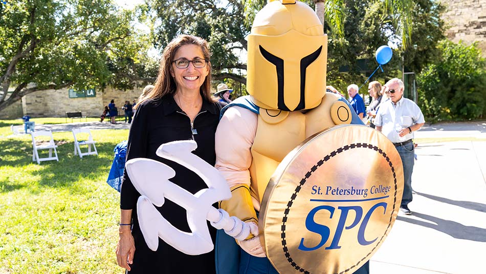 SPC Alumna Nicole Stott posing with Titus, the Titan mascot at SPC Day