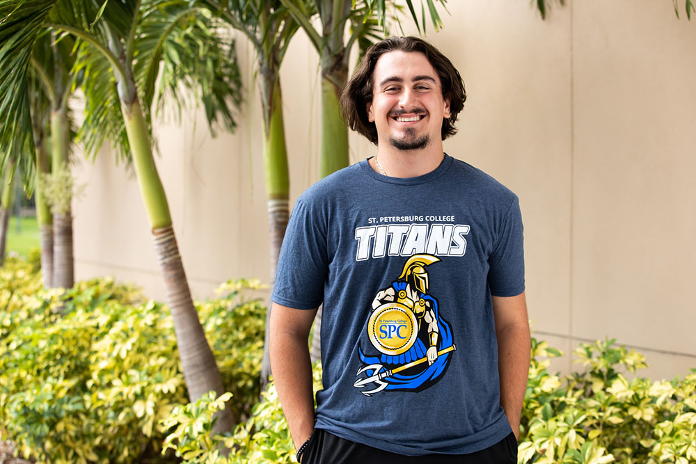 happy male sudents in a blue Titans tshirt smiling