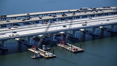 construction equipment at the site of the replacement Howard Frankland Bridge between Tampa and St. Pete