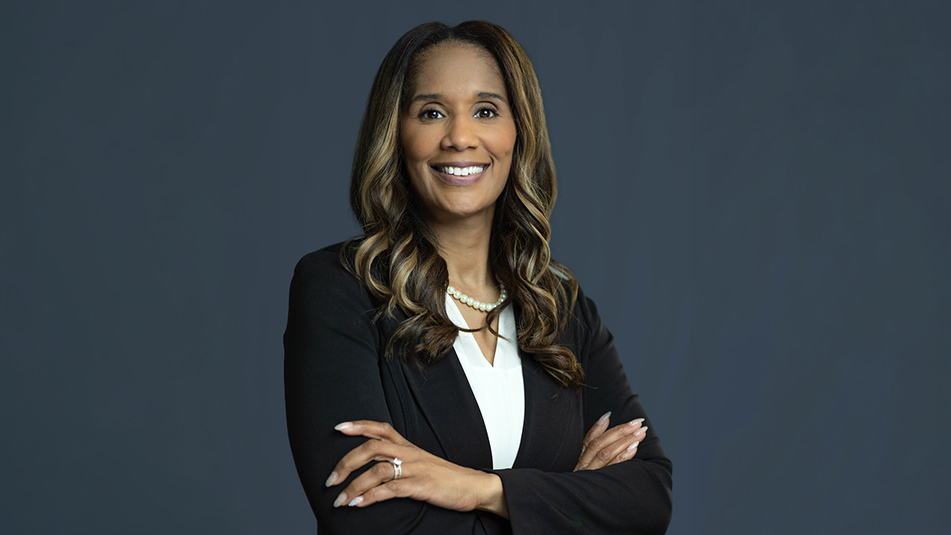 portrait of Raquel Hairston in a black suit and black shirt