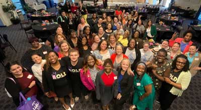 overhead photos of conference attendees in a conference room smiling