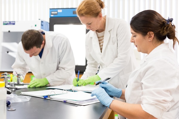 students working in a laboratory taking notes