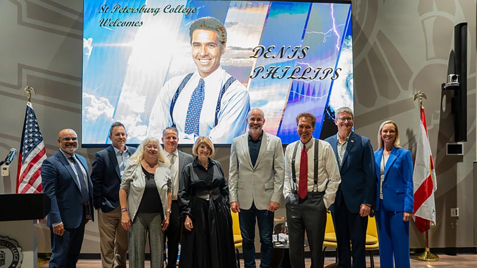 Denis Phillips standing with a group of people at the Workforce Innovation Hub