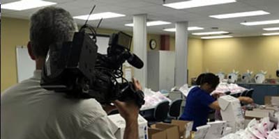 a camera person from the press covering an SPC volunteer event