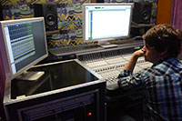 student working at a sound board