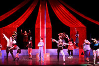 students performing in a play on a Theater stage