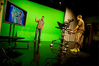 student in front a green screen in a tv studio