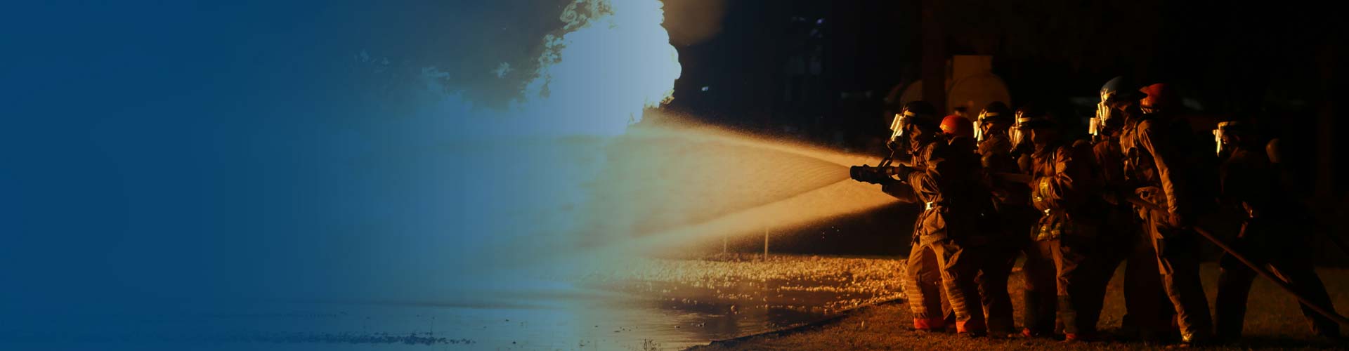 blue gradient image with firefighters using a hose on bright orange flames